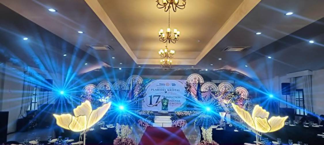 Induction ceremony stage with blue beam lights