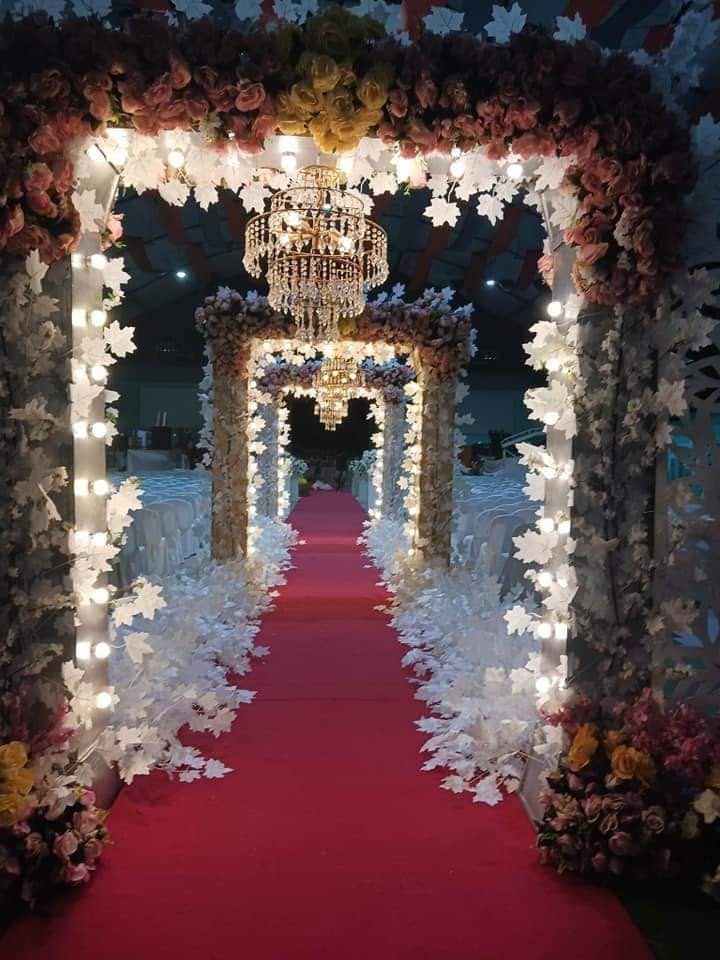 Lighted arches over a red carpet aisle