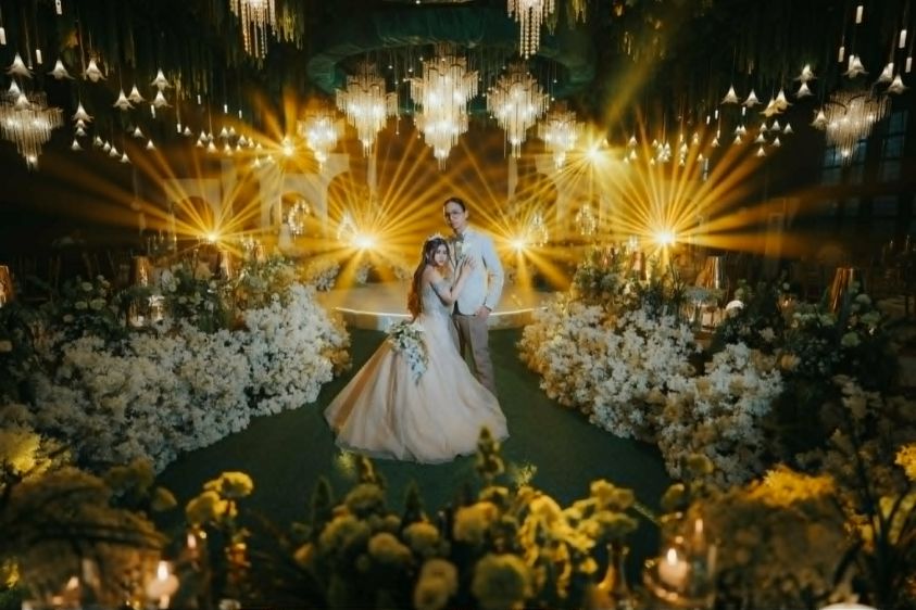 Couple under golden beam lights