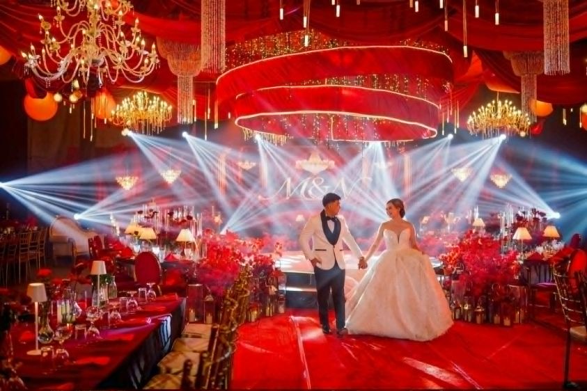Red-themed wedding with white beam lights
